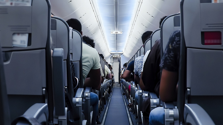 the economy section of a flight from the back