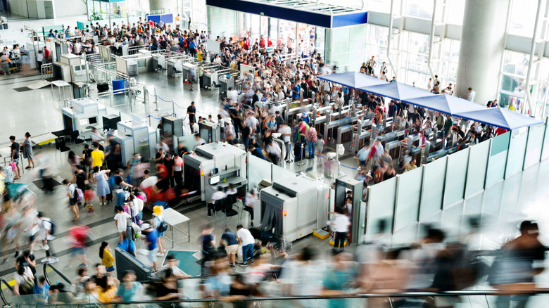 Overhead of travelers crossing airport security