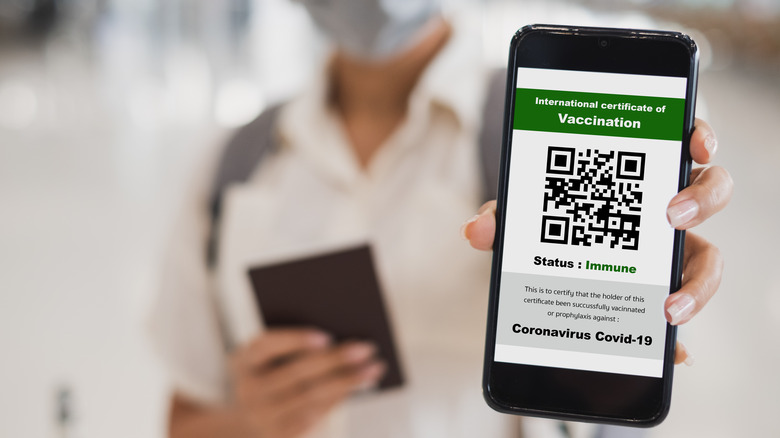 Man holding digital vaccine passport  