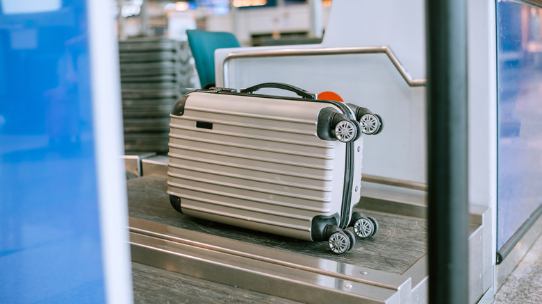 Suitcase on airport conveyor belt