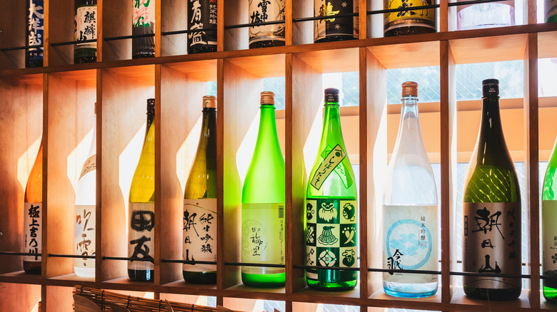 Sake bottles on shelves in a bar in Japan