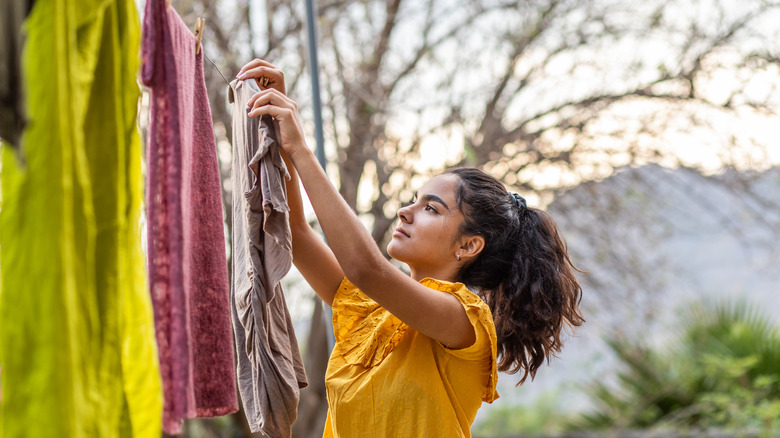 woman hanging laundry outside