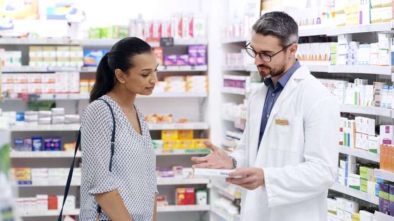Pharmacist giving advice to customer
