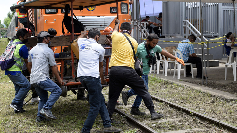people moving rail trolley in Philippines