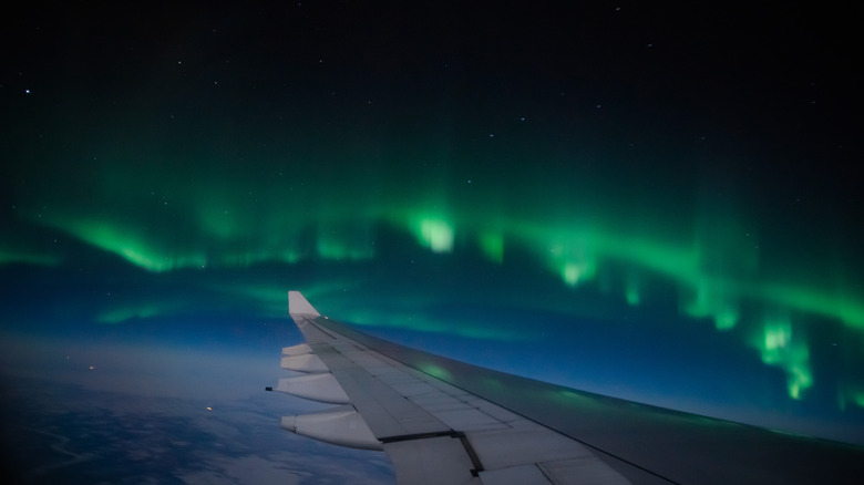 plane flying past aurora