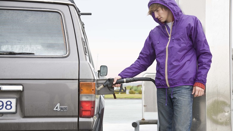 man pumping gas