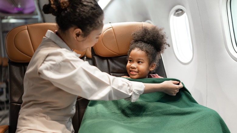 Little kid with airplane blanket