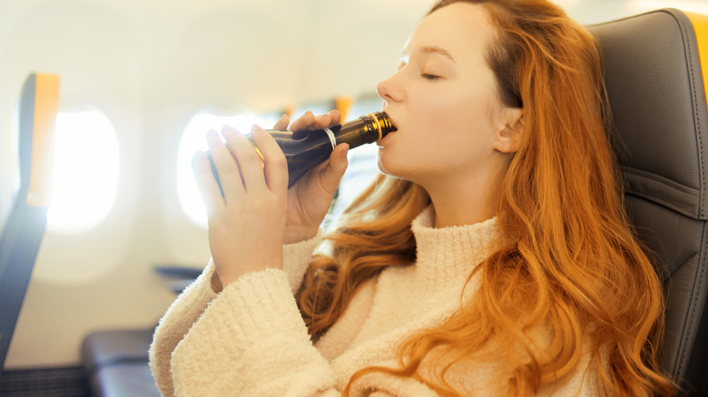 Woman drinking wine on flight