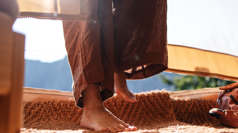 standing barefoot on camping mat