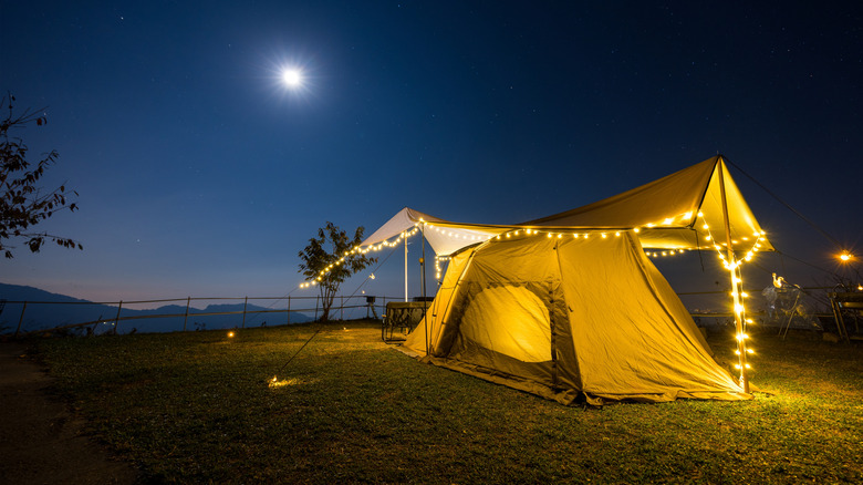 tent with tarp fastened above it