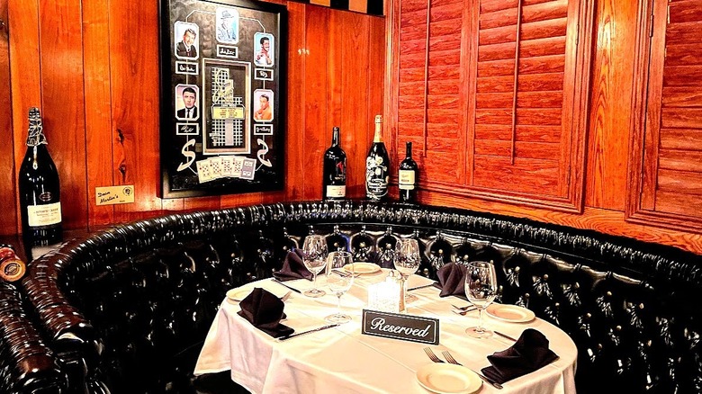 table, leather booth, and wooden walls