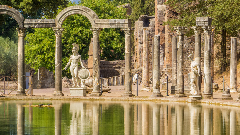 columns and statues reflecting into water