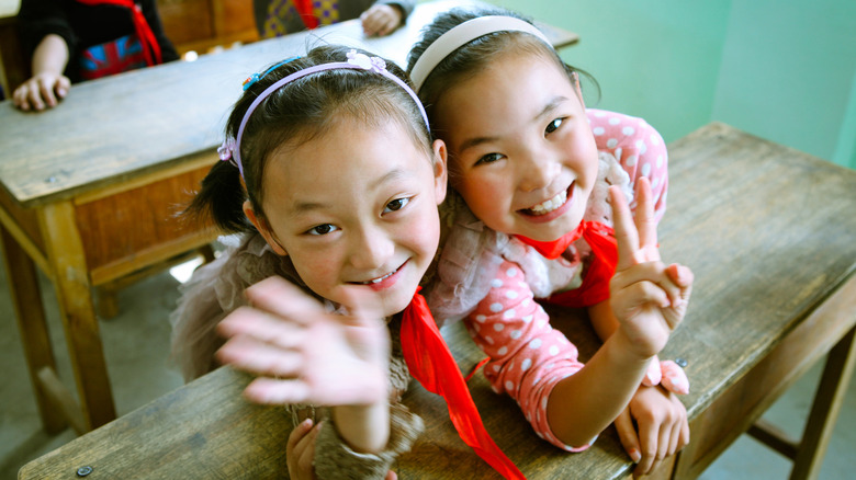 Chinese school children waving