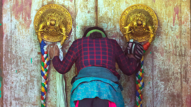 Woman bowing at monestary