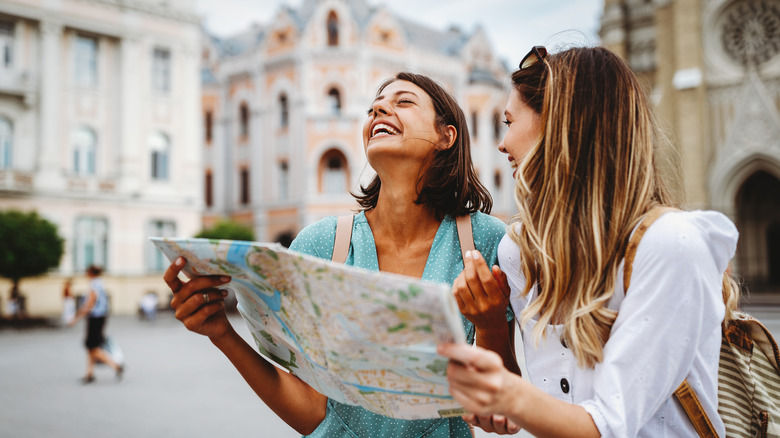 Two girls reading map