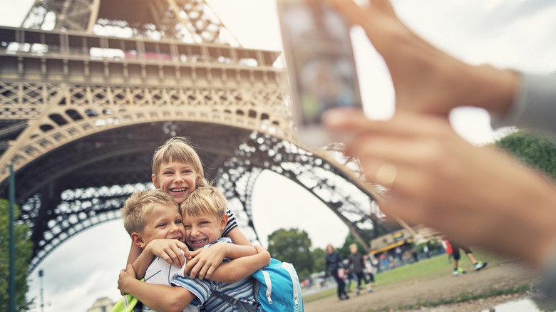 Kids posing at Eiffel Tower.