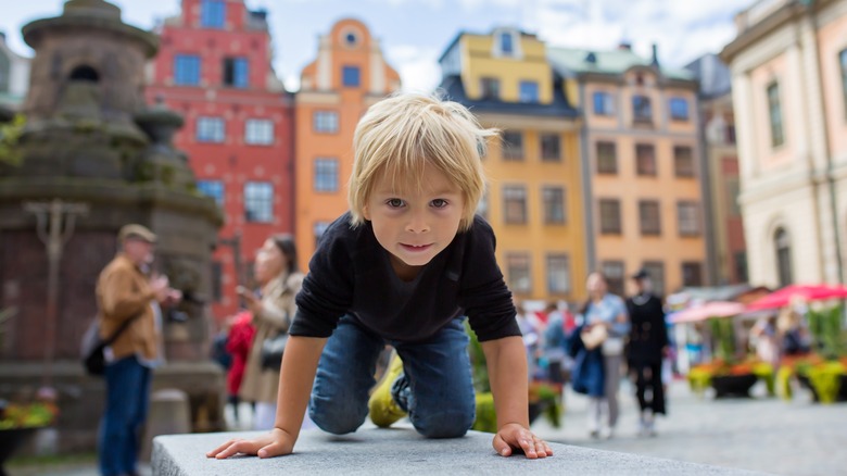 Kids playing in Stockholm plaza.