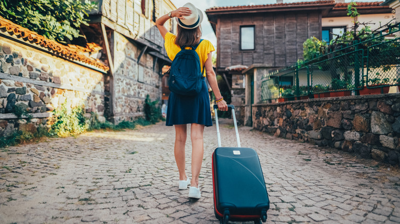 Woman walking with suitcase