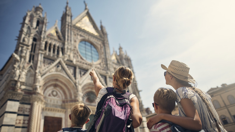 Tourist family pointing to a cathedral