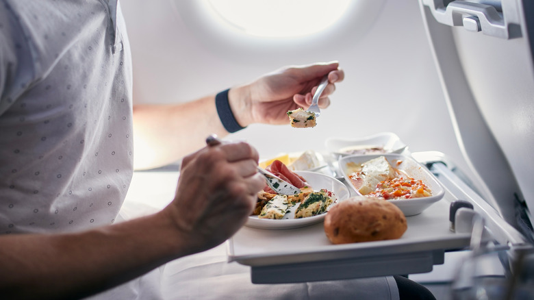 Man eating an airplane meal