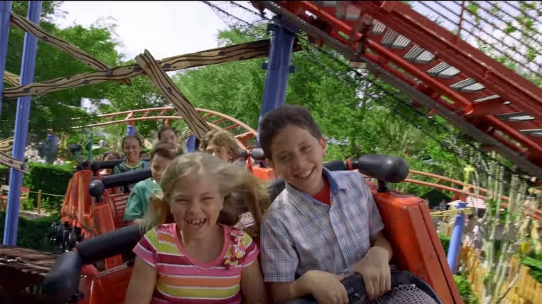 Kids smiling on Woody Woodpecker's Nuthouse Coaster