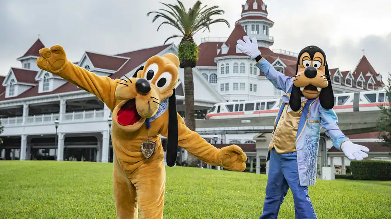 Pluto and Goofy in 50th anniversary blue/purple outfits