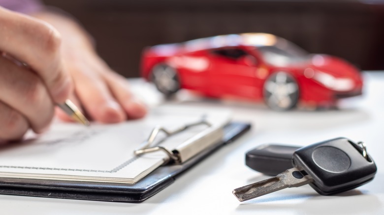 signing document by car keys