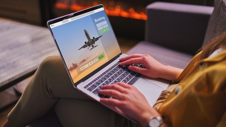 Person booking a trip on laptop 