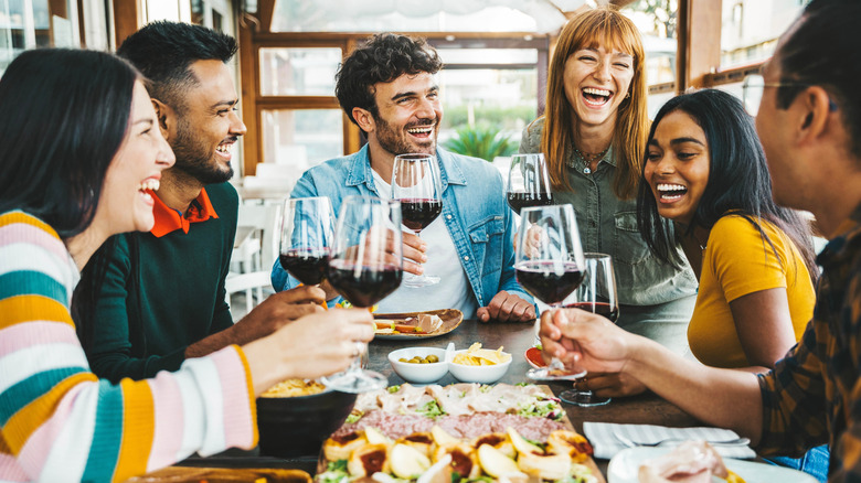 A group of friends enjoying wine and snacks