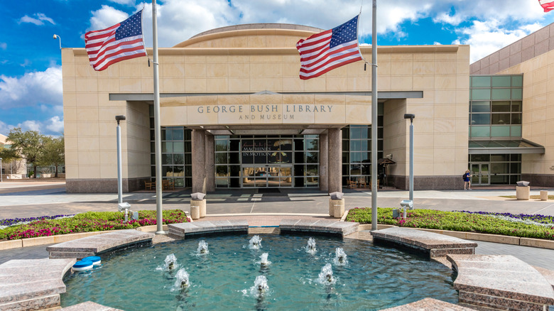 American flags and a fountain outside the entrance to the George Bush Library and Museum.