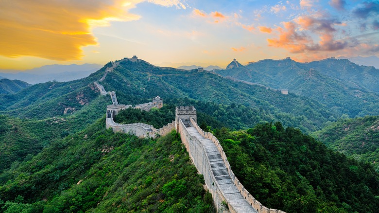 Great Wall of China through lush green mountains