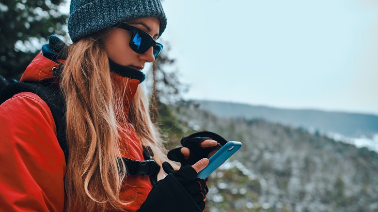 Hiker with her phone out 