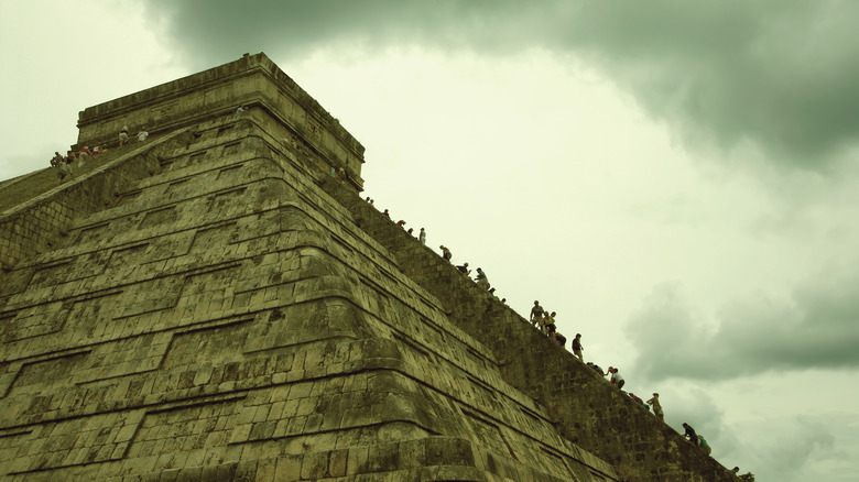 People climbing El Castillo pyramid