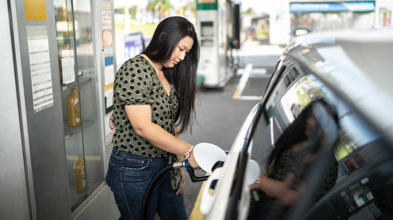 Woman filling gas tank