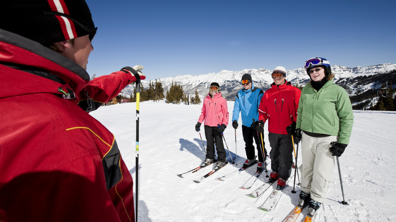 Group with instructor learning to ski