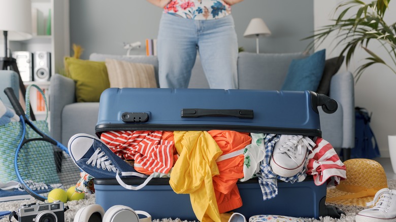 clothes spilling out of suitcase 