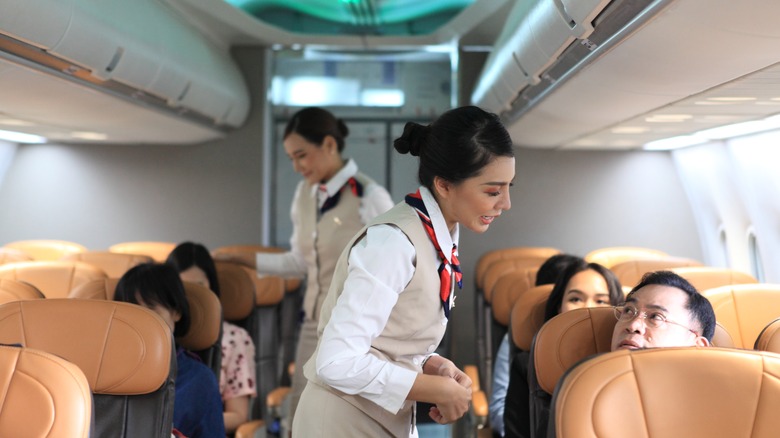 flight attendants with passengers