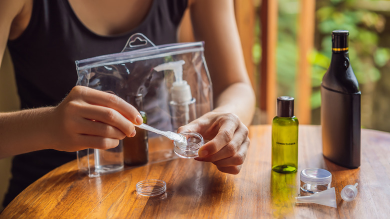 Traveler packing their toiletries