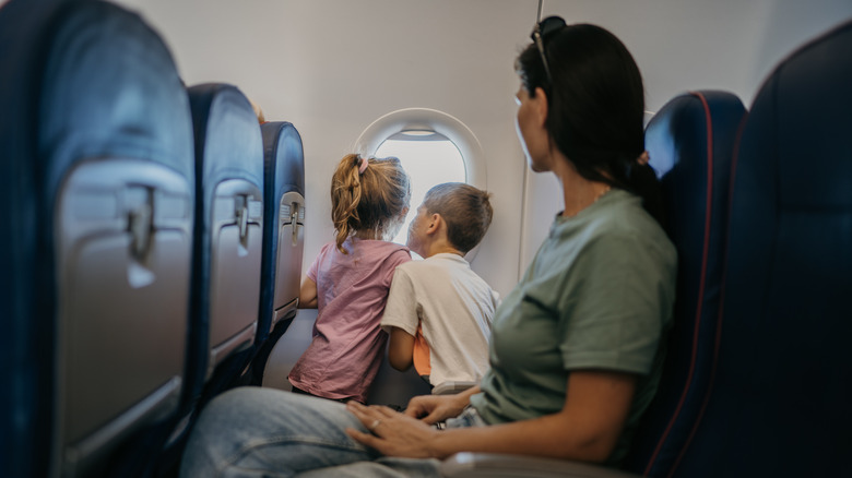 parent with kids on plane