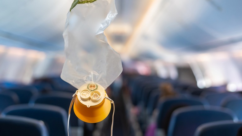 Airplane oxygen mask hanging down