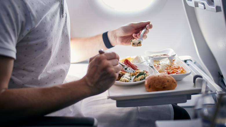 Man eating on a plane 