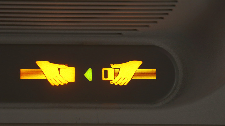 seatbelt sign lit up airplane