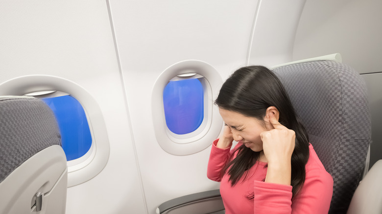 woman with ear pain airplane