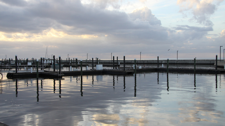 Boat dock reflecting on the water on a cloudy day