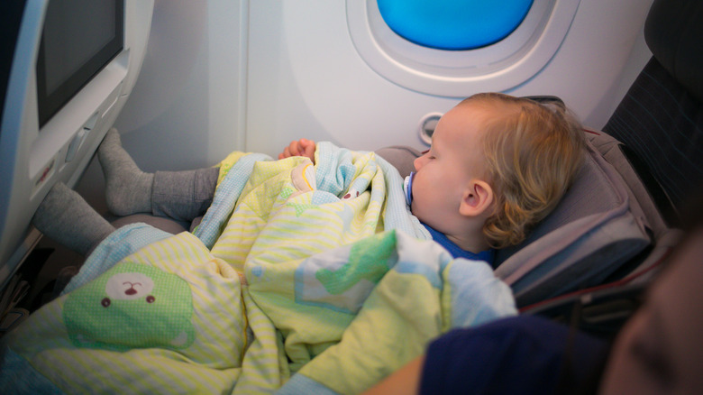 baby in seat on plane