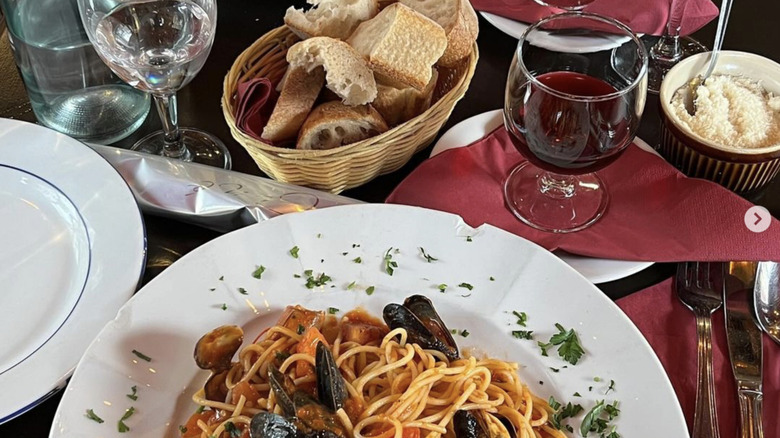 Pasta, wine, and bread on table