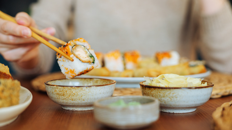 person eating sushi