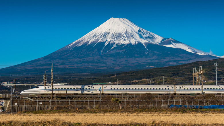 A bullet train speeds past Mt. Fuji