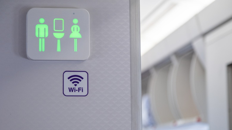 green lavatory sign on airplane