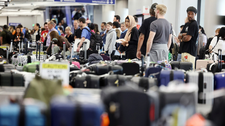 Ornery travelers wait for luggage at airport carousel